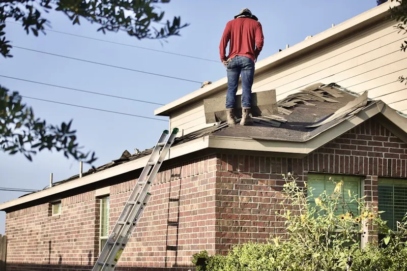 Professional roofer working on a residential roof in Marble Falls